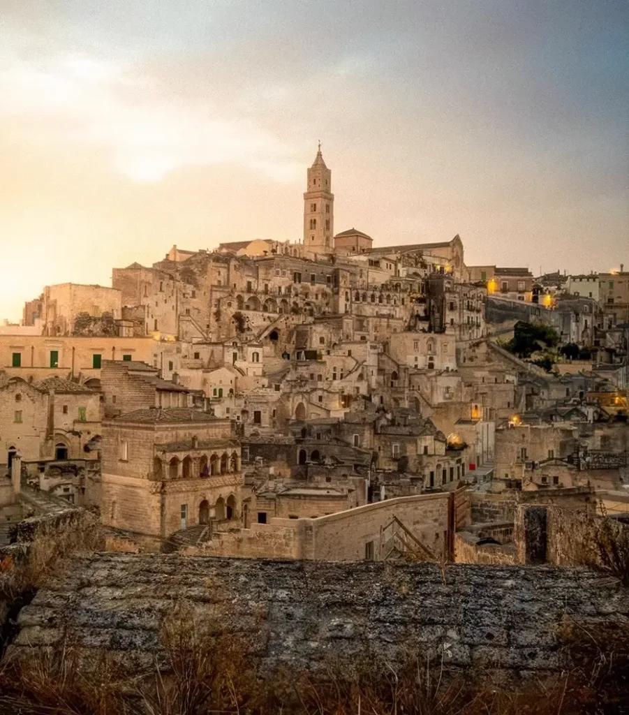 Sunset over the ancient stone city of Matera with golden light on the Sassi cave dwellings