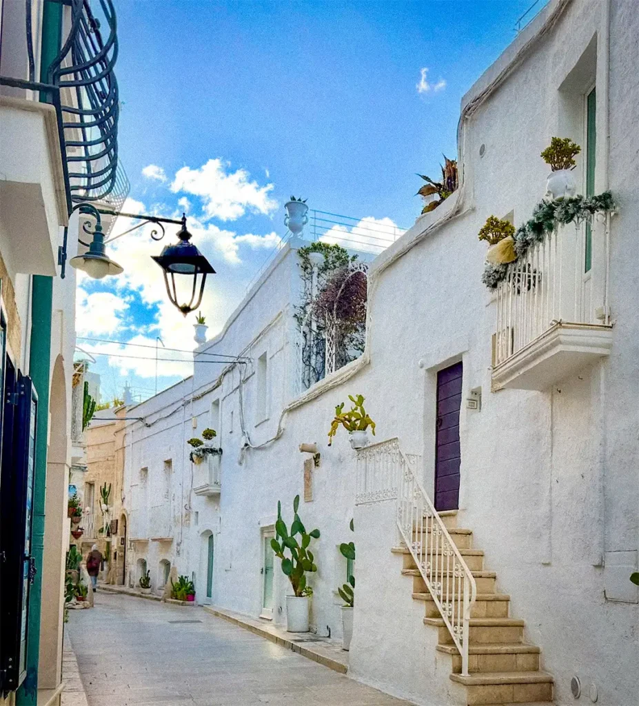 Whitewashed architecture and buildings cascading down the hillside in Ostuni, Puglia