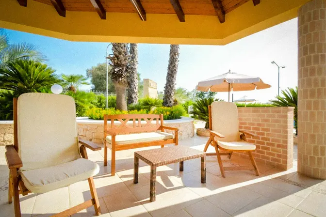 Shaded gazebo beside pool at private villa in Puglia Italy
