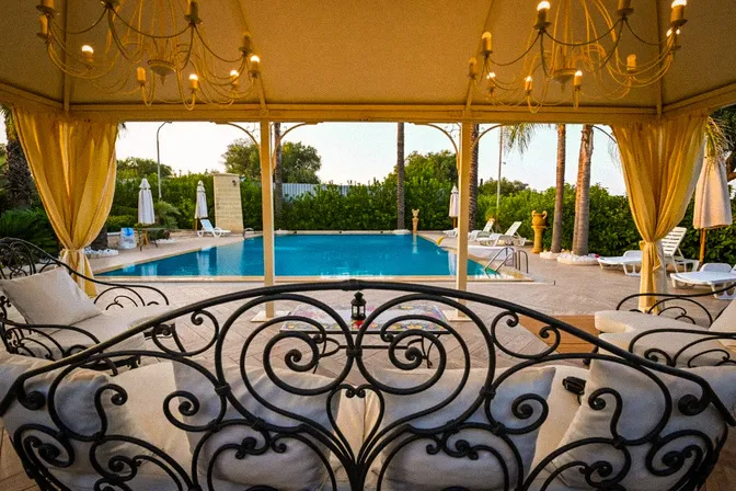 Golden sunset over private villa pool in Puglia countryside