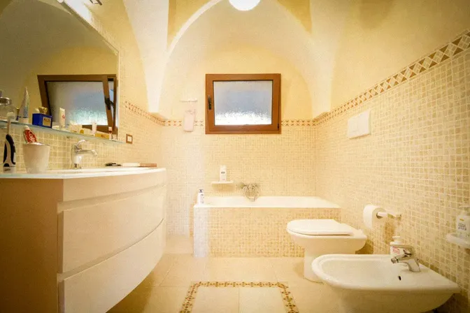 Bathroom with traditional ceramic tiles at villa in Puglia Italy