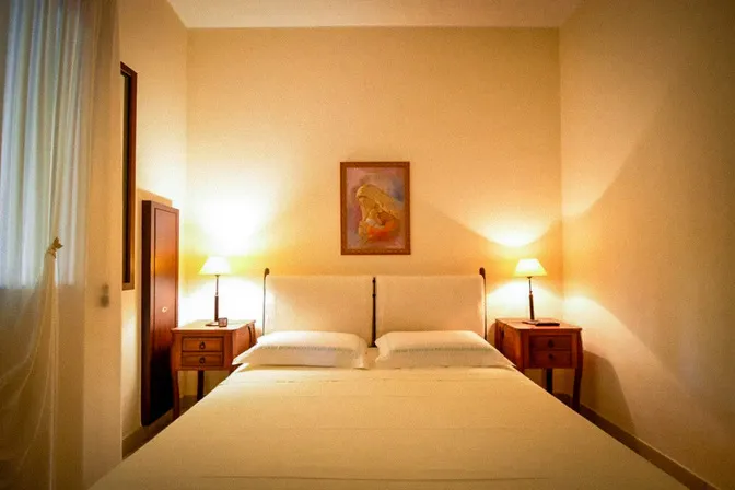 Peaceful bedroom with traditional Italian linens at Puglia countryside villa